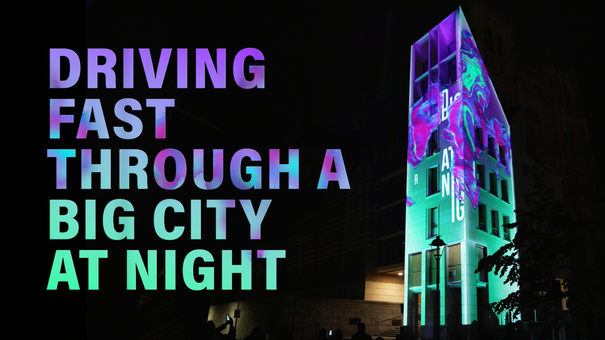 DRIVING FAST THROUGH A BIG CITY AT NIGHT